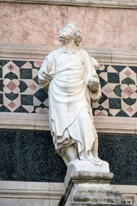 Statue of buddha against wall