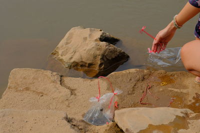 Midsection of woman catching fish in river