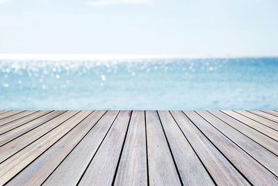 Surface level of pier on sea against clear sky