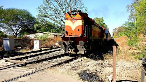 Train on railroad track against sky