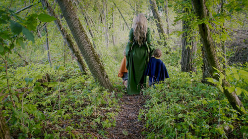 Rear view of woman walking in forest