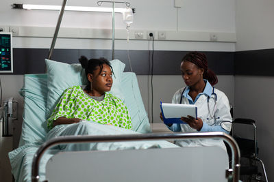 Female doctor examining patient in hospital