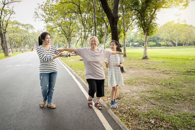 Rear view of people walking in park