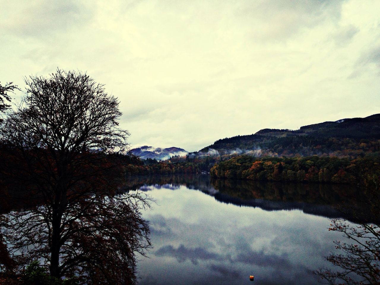 reflection, lake, tranquil scene, water, tranquility, sky, scenics, beauty in nature, mountain, tree, cloud - sky, nature, cloud, mountain range, idyllic, standing water, waterfront, non-urban scene, calm, cloudy