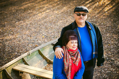 Portrait of smiling young couple standing outdoors