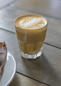 Close-up of coffee glass on table