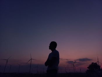 Rear view of man standing against clear sky