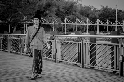 Woman standing on footbridge