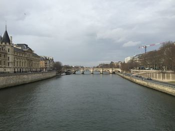 View of bridge over river against cloudy sky