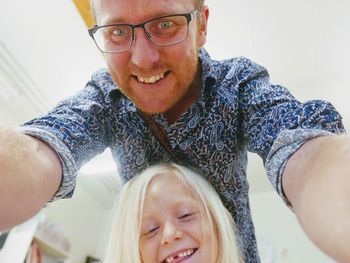 Portrait of smiling father with cute daughter