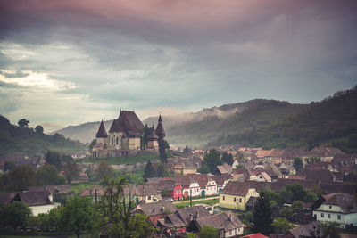 Buildings in town against sky