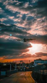 View of airport runway against sky during sunset