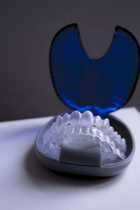 Close-up of plastic dentures in box on table