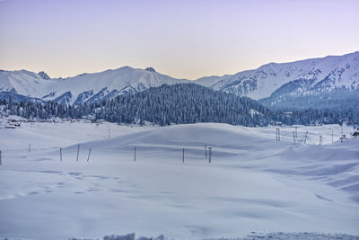 Scenic view of snow covered mountains against sky