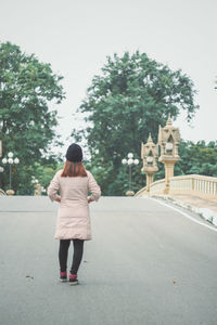 Rear view of woman walking on street in city