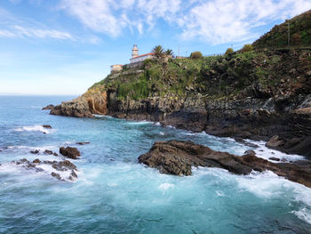 Rocks on beach against sky