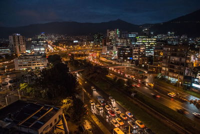 High angle view of illuminated cityscape against sky at night