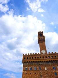 Low angle view of clock tower against sky