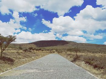Scenic view of land road against sky