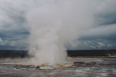 Smoke on hot spring against sky