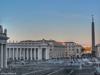 View of buildings in city against sky during sunset