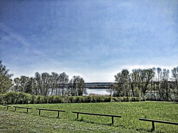 Scenic view of grassy field against cloudy sky