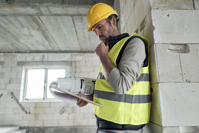 Rear view of man working at construction site