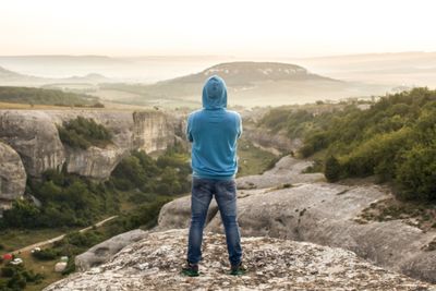 Rear view of man standing on mountain