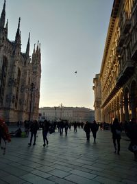 People in city against sky