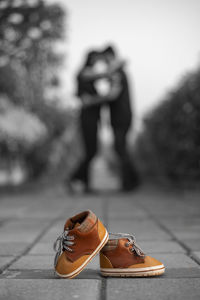 Low section of woman standing on footpath