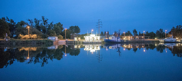 Scenic view of lake against clear blue sky at night