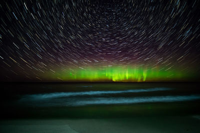 Scenic view of lake against clear sky at night