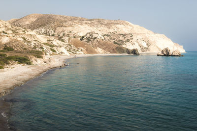 Scenic view of sea and mountains against clear sky