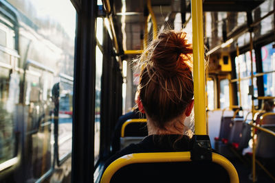 Rear view of woman in train