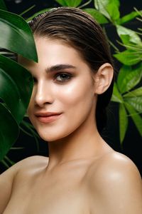 Close-up portrait of woman against plants