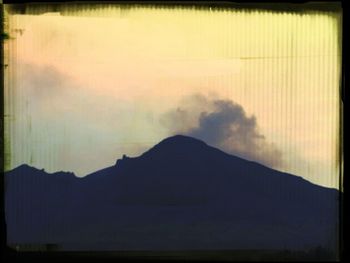 Scenic view of mountains against sky at sunset