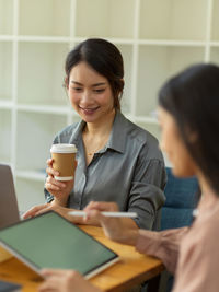 Woman having coffee at office