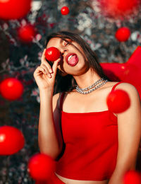  young woman holding a tomato