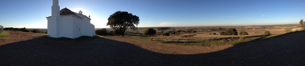 Panoramic view of field against sky