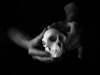 Close-up of person hand against black background