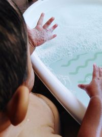 Midsection of woman holding hands in water