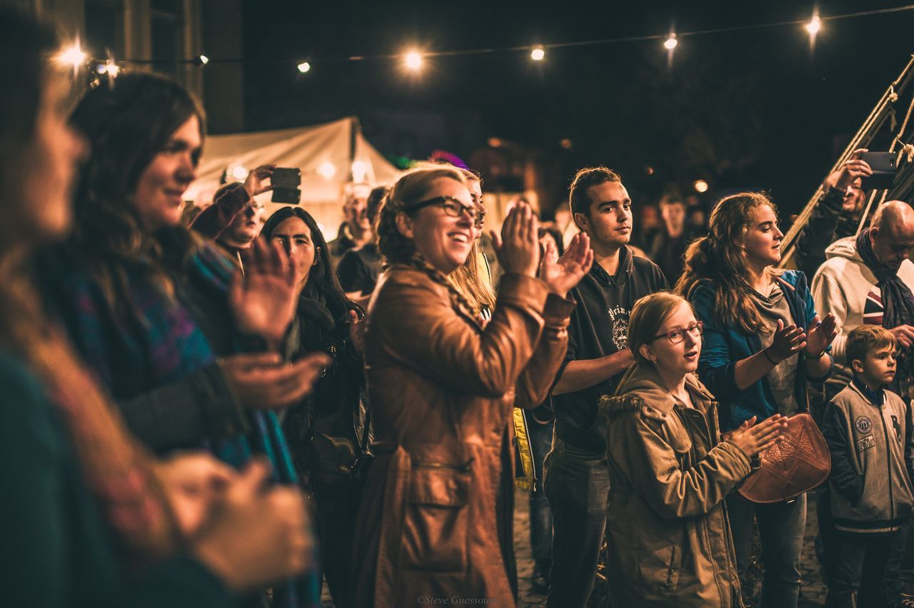 GROUP OF PEOPLE ENJOYING MUSIC CONCERT