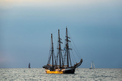 Sailboat sailing on sea against sky