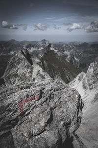 Scenic view of mountains against cloudy sky