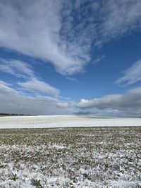 Scenic view of land against sky during winter