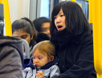 Close-up of young woman sitting in train