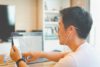 Portrait of man working  on laptop at home