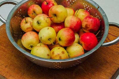 Small apples in a colander, fresh autumn harvest