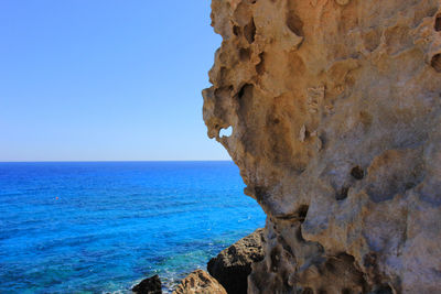 View of calm blue sea against clear sky