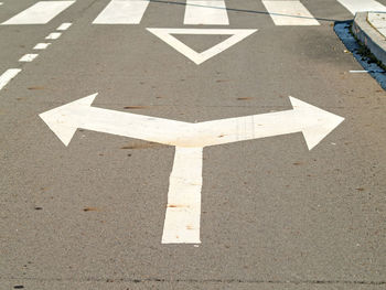 Close-up of arrow signs on street